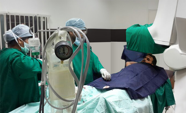 Medical team performing a procedure in the operation theatre